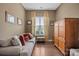Cozy living room featuring a comfortable couch, patterned curtains, and a wooden cabinet, creating a warm atmosphere at 423 Granite Lake Ct, Denver, NC 28037
