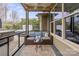Cozy screened-in patio features comfortable seating, a ceiling fan, and access to the outdoor hot tub area at 423 Granite Lake Ct, Denver, NC 28037