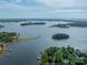 Beautiful aerial view of a lake with islands and homes nestled along the shoreline with lush greenery at 4646 Eagle Pointe Ct, Denver, NC 28037