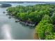 Aerial view featuring a lake house with a boat dock and several boats, perfect for a relaxing lakeside getaway at 4646 Eagle Pointe Ct, Denver, NC 28037