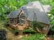 Backyard featuring a well-maintained deck with plenty of space, a stunning brick house and mature trees providing privacy at 4646 Eagle Pointe Ct, Denver, NC 28037