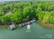 Scenic aerial view showcasing the boat slip and lush greenery surrounding the Lake Norman property at 4646 Eagle Pointe Ct, Denver, NC 28037