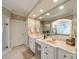 Spacious bathroom featuring a double sink vanity, decorative wallpaper and a large mirror that reflects the adjacent tub and shower at 4646 Eagle Pointe Ct, Denver, NC 28037