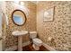 Powder room featuring a floral wallpaper and pedestal sink at 4646 Eagle Pointe Ct, Denver, NC 28037