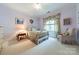 Light-filled bedroom with a large window and a chair at 4646 Eagle Pointe Ct, Denver, NC 28037