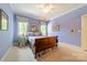 Light blue bedroom with a large bed, side tables, and bright windows at 4646 Eagle Pointe Ct, Denver, NC 28037