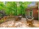 Inviting wooden deck featuring a seating area surrounded by lush greenery and mature trees providing privacy at 4646 Eagle Pointe Ct, Denver, NC 28037