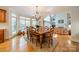 Dining room with large windows, hardwood floors, and view into the living room at 4646 Eagle Pointe Ct, Denver, NC 28037