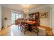 Formal dining room featuring a large window, hardwood floors, and elegant chandelier at 4646 Eagle Pointe Ct, Denver, NC 28037