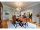 Spacious dining room with a dining table, wainscoting, and views into living room at 4646 Eagle Pointe Ct, Denver, NC 28037