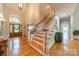 Grand foyer with hardwood floors, staircase, and a large arched window on the front door at 4646 Eagle Pointe Ct, Denver, NC 28037