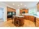 Kitchen with stainless appliances, custom cabinets, kitchen island, and hardwood floors at 4646 Eagle Pointe Ct, Denver, NC 28037