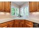 Well-lit kitchen sink area featuring corner windows with views of the landscape at 4646 Eagle Pointe Ct, Denver, NC 28037