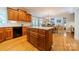 Open kitchen featuring a large island, custom cabinets, and a view of the dining room at 4646 Eagle Pointe Ct, Denver, NC 28037