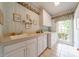 Well-lit laundry room features a sink, ample cabinet space and a washer and dryer at 4646 Eagle Pointe Ct, Denver, NC 28037