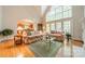 Bright living room with a vaulted ceiling, large windows, and floral sofas open to the kitchen at 4646 Eagle Pointe Ct, Denver, NC 28037