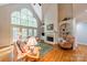 Bright living room features a fireplace, built-in shelving and expansive windows at 4646 Eagle Pointe Ct, Denver, NC 28037