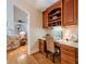 Charming office space with custom built-in shelving and a view of the living room at 4646 Eagle Pointe Ct, Denver, NC 28037