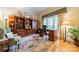 Cozy office with built-in bookshelves, a comfortable armchair, and a large window at 4646 Eagle Pointe Ct, Denver, NC 28037