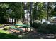 Shaded picnic area with green table and seating surrounded by lush greenery and trees at 4646 Eagle Pointe Ct, Denver, NC 28037