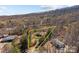 Aerial view showcasing property lines in a wooded setting with a house, yard, and neighborhood visible at 4793 Appaloosa Ln, Maiden, NC 28650
