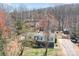 An elevated exterior view of a white home with vinyl siding and blue trim surrounded by tall trees at 4793 Appaloosa Ln, Maiden, NC 28650