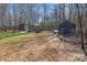 Backyard with a fire pit, hammocks, storage sheds, and fenced perimeter at 4793 Appaloosa Ln, Maiden, NC 28650