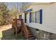 Exterior angle view of the home's entrance and porch with white siding and blue trim at 4793 Appaloosa Ln, Maiden, NC 28650