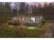 Charming single-story home with a wooden porch, stone foundation and mature trees in a wooded setting at 4793 Appaloosa Ln, Maiden, NC 28650