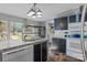 Bright kitchen with black cabinets, stainless steel sink, and view to landscaped backyard at 4793 Appaloosa Ln, Maiden, NC 28650