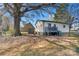 Home featuring a backyard with a shed, porch and mature trees at 501 S Inman Ave, Bessemer City, NC 28016