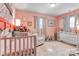 Delightful Bedroom with pink walls, crib, comfy chair and playful accents at 501 S Inman Ave, Bessemer City, NC 28016