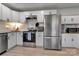 Well-equipped kitchen with stainless steel appliances, white cabinets, and granite countertops at 501 S Inman Ave, Bessemer City, NC 28016