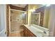 Bathroom with shower, double sink vanity, and attractive vanity lighting at 5016 Haybridge Rd, Charlotte, NC 28269