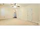 Spacious bedroom includes neutral carpet, a ceiling fan, and multiple doorways for flexible living at 5016 Haybridge Rd, Charlotte, NC 28269