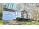 Well-maintained home featuring a two-car garage, brick details, and manicured landscaping at 5016 Haybridge Rd, Charlotte, NC 28269