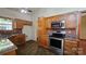 Well-lit kitchen featuring wood cabinetry, stainless steel appliances, and sleek countertops at 5016 Haybridge Rd, Charlotte, NC 28269