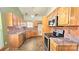 Well-lit kitchen featuring stainless steel appliances, granite countertops, and ample cabinet space at 5016 Haybridge Rd, Charlotte, NC 28269