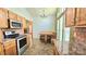 Eat-in kitchen with granite counters, stainless appliances, and breakfast nook seating with backyard view at 5016 Haybridge Rd, Charlotte, NC 28269