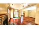 Bright living room with hardwood floors, a brick fireplace, and seamless access to other rooms at 5016 Haybridge Rd, Charlotte, NC 28269