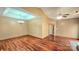 Open-concept living room featuring hardwood floors, neutral walls, and a modern ceiling fan at 5016 Haybridge Rd, Charlotte, NC 28269
