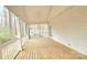 Open screened porch area with wood flooring, and an inviting hammock in the distance at 5016 Haybridge Rd, Charlotte, NC 28269