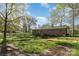 This backyard features a well-maintained lawn, mature trees, and a brick home exterior at 518 W Westview St, Gastonia, NC 28052