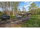 Quaint home with mature trees, a covered porch, attached carport, and a long driveway at 518 W Westview St, Gastonia, NC 28052