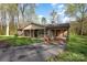 Inviting brick home featuring a covered front porch, attached carport, and convenient driveway access at 518 W Westview St, Gastonia, NC 28052