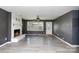 Bright living room with laminate flooring, fireplace, and large windows for comfortable living and entertaining at 518 W Westview St, Gastonia, NC 28052