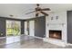 Living room featuring a brick fireplace, ceiling fan, and sliding glass door at 518 W Westview St, Gastonia, NC 28052