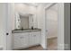 Bathroom featuring dual sinks with granite countertops, white cabinets, and modern hardware at 5611 Skinny Down, Charlotte, NC 28215