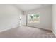 Inviting bedroom with neutral walls, plush carpeting, and natural lighting at 5611 Skinny Down, Charlotte, NC 28215