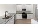 Modern kitchen with stainless steel appliances, granite countertops, and white cabinetry at 5611 Skinny Down, Charlotte, NC 28215